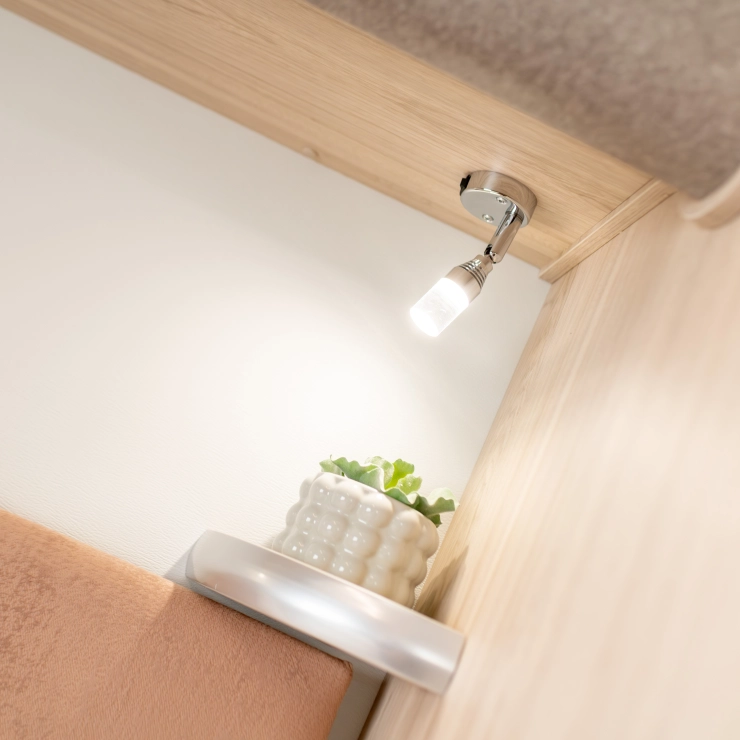 Lightings above the bedframe inside the bedroom area of the Whirlwind caravan.
