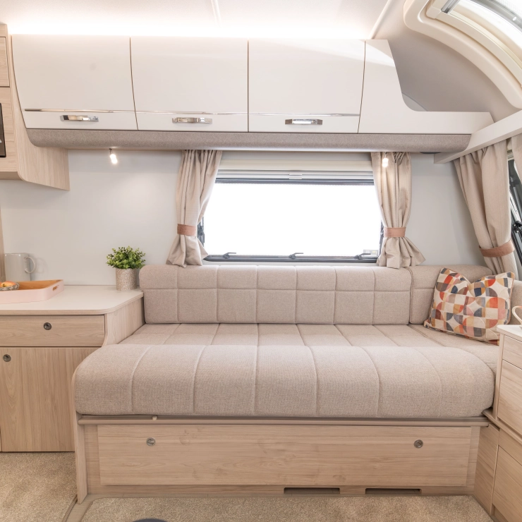 Side shot of the Whirlwind 520. It mainly shows the sofa closest to the entrance door, with draws above the seating and storage cupboards below and side of sofa.