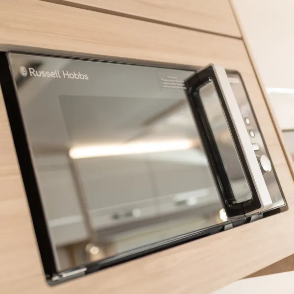 Image of a Russell Hobbs microwave inside the Whirlwind caravan range
