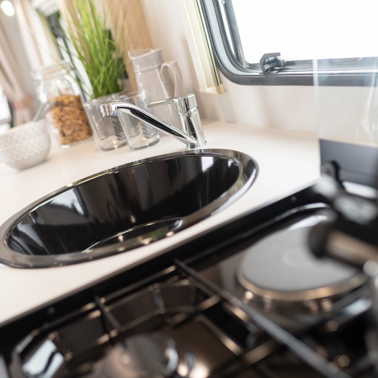 A close up image of the kitchen and sink area inside the Whirlwind 554.