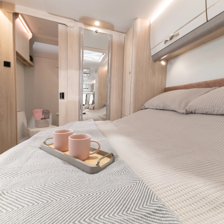 Another image of the bedroom inside the Whirlwind 554. Showcasing the transverse rear island bed.