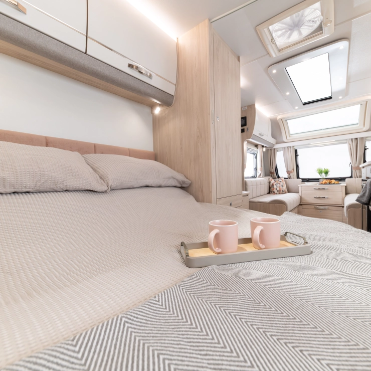 Another image of the bedroom inside the Whirlwind 554. Showcasing the transverse rear island bed from a different angle